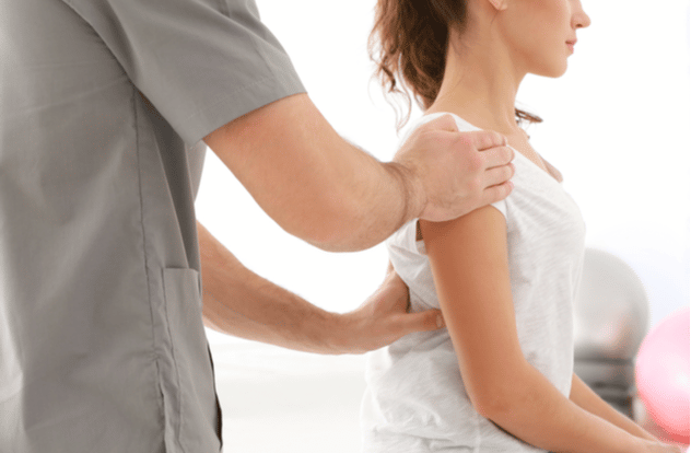 Physiotherapist working with patient in clinic closeup