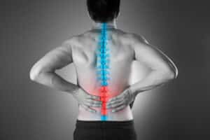 Pain in the spine, a man with backache, injury in the lower back
